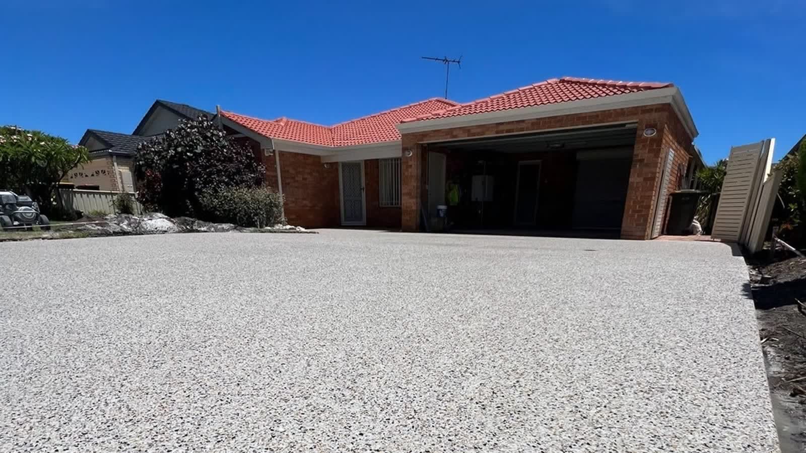 Exposed aggregate concrete driveway, freshly sealed